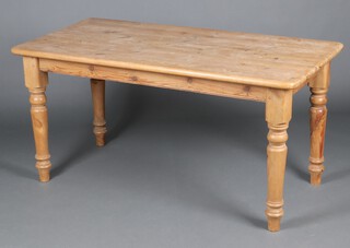 A Victorian style rectangular pine kitchen table, raised on turned supports 75cm h x 75cm w x 172cm l 