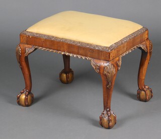 A Queen Anne style rectangular walnut stool with upholstered drop in seat, raised on cabriole, ball an claw supports 46cm h x 62cm w x 48cm d