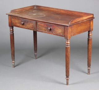 A Victorian mahogany wash stand with 3/4 gallery, fitted 2 drawers, raised on turned and reeded supports 82cm h x 106cm w x 55cm d  
