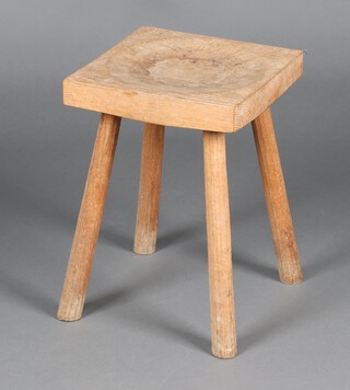 An oak stool, raised on turned supports, base marked A McCII 1997 48cm h x 34cm w x 33cm d 