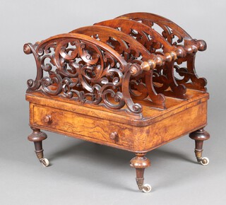 A Victorian figured and walnut 3 division Canterbury with pierced decoration to the panels, the base fitted a drawer, raised on turned supports with ceramic casters 52cm h x 51cm w x 37cm d 