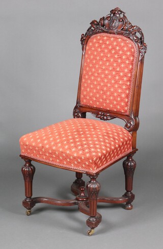 A Victorian pierced and carved mahogany high back hall chair, the crest carved leaves and stags head, having an upholstered seat and back, raised on turned and fluted supports with X framed stretcher 107cm h x 49cm w x 46cm d (seat 25cm x 30cm) 