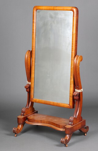 A Victorian plate cheval mirror contained in a carved mahogany stand with carved tulips to the sides, raised on scroll feet 139cm h x 70cm w x 50cm d 