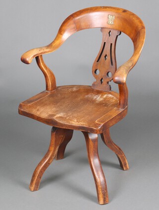 A Victorian bleached mahogany tub back revolving office chair with pierced vase shaped slat back, having a gilt metal T M monogram to the back, raised on shaped supports 91cm h x 49cm w x 50cm d (seat 63cm x 32cm) 