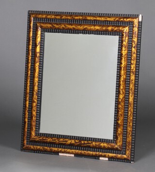 A 19th Century rectangular plate mirror contained in a tortoiseshell effect and ebonised cushion shaped frame 69cm x 49cm 
