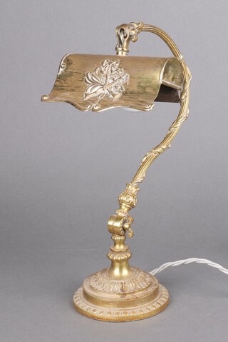 A brass desk lamp, the shade decorated musical instruments, raised on a circular base 35cm h x 13cm 