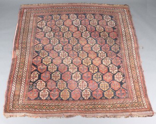 A blue, red and white ground Persian carpet with overall gold pear or cone design 200cm x 186cm 