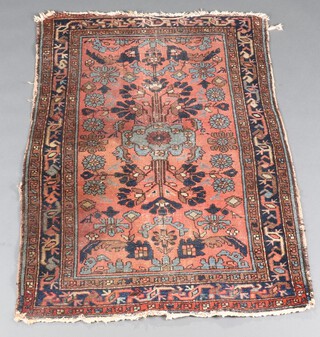 A blue and red North Persian floral patterned rug with central floral medallion 137cm x 94cm  