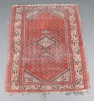 A tan, blue and white ground Caucasian style rug with diamond shaped medallion to the centre within a 3 row border 147cm x 107cm 