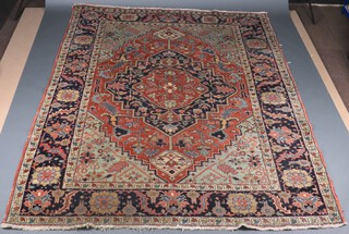 A brown and blue ground North Persian carpet with central diamond floral medallion within a 3 row border 291cm x 219cm 