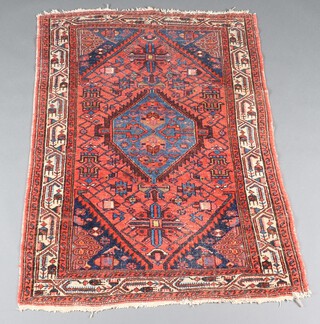 A red and blue ground Persian rug with diamond medallion to the centre within a multi row border 149cm x 101cm 