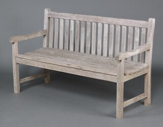 A well weathered slatted teak garden bench (marked Teak Plantation Timber) 90cm h x 150cm w x 60cm d 