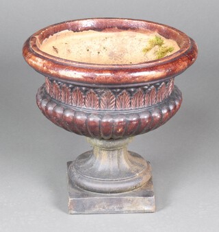 A Doulton style brown glazed circular urn with leaf and lobed body, raised on an associated base with square foot 49cm h x 50cm diam. (in 2 sections)