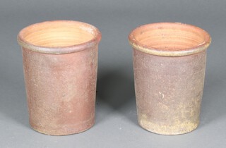 A pair of well weathered brown glazed terracotta cylindrical garden urns 30cm h x 26cm diam. 