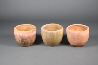 Three well weathered circular terracotta planters 30cm x 38cm 