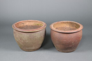 A near pair of circular brown glazed terracotta plant pots 37cm x 50cm and 38cm x 54cm 