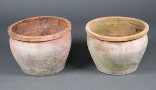 Two similar well weathered circular terracotta garden urns 35cm h x 50cm and 34cm x 49cm 