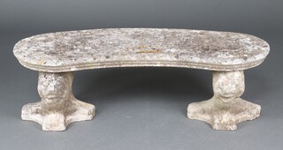 A well weathered crescent shaped concrete garden bench on lion supports 38cm h x 119cm w x 47cm d 
