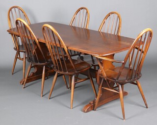 Ercol, a dark elm dining suite comprising rectangular dining table on standard supports with H framed stretcher 71cm h x 182cm l x 78cm w (water and contact marks in places) and 6 comb back dining chairs - 2 carvers, 4 standard, raised on turned supports with H framed stretchers 97cm h x 42cm w 