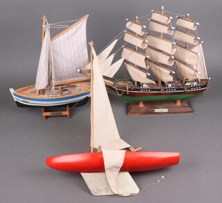 An Albatross Model Boats pond yacht 54cm x 40cm, wooden model of The Cutty Sark 43cm x 48cm and a 1 other of a fishing boat 41cm x 31cm 