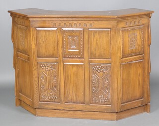 A carved oak bar, of curved form, 106cm h x 151cm w x 56cm d 