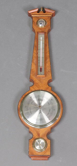 A Georgian style aneroid barometer and thermometer contained in a wheel case 68cm h x 20cm 