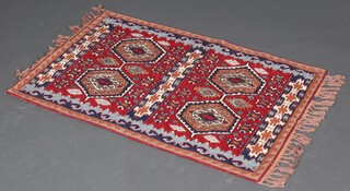 A brown and blue ground Kilim style woven rug with 4 octagons to the centre 115cm x 76cm 