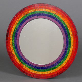 A Balinese circular plate mirror contained in a rainbow mosaic style frame 45cm diam. 
