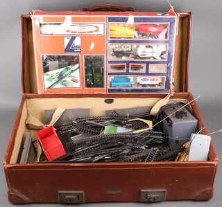 A Lima train set, a Lima tank engine, 1 other tank engine together with various items of rolling stock, a Clipper Power Control Unit and various rails, contained in a leather case  