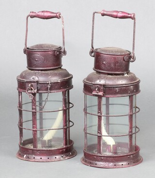 Two cylindrical metal hand lanterns 