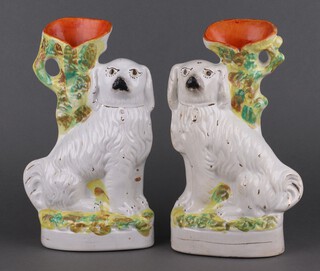 A pair of Victorian Staffordshire spaniel spill vases 33cm 