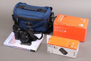 A Sony a6100/ILCE-6100 digital camera with camera case and guide, a Sony FE 70-300mm F4.5-5.6 G OSS lens together with a Sony BC-TRW battery charger 