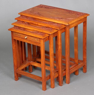 A nest of 4 rectangular Burmese carved hardwood and inlaid brass coffee tables, the smallest fitted a drawer, 51cm h x 52cm w x 31cm d 