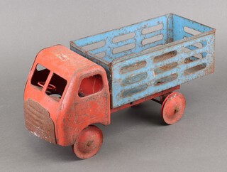 A Triang red and blue pressed metal model of a lorry 19cm x 43cm x 16cm (wheels perished)