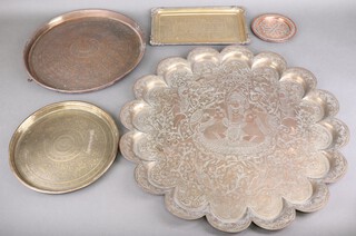 A Benares brass circular tray 60cm diam., 3 smaller ditto and rectangular ditto 