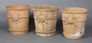 A set of 3 fibre glass, terracotta effect, garden urns with rope edge borders and classical mask decoration 44cm x 40cm diam. 