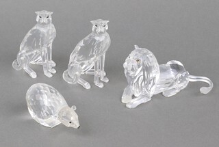 A Swarovski Crystal  figure of a reclining lion 12cm, 2 cheetahs 9cm and a polar bear 7cm 