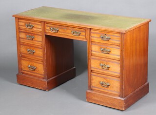 An Edwardian walnut desk with green leather inset writing surface, fitted 1 long and 8 short drawers, raised on a platform base 75cm h x 130cm w x 49cm d (desk in 1 section) 