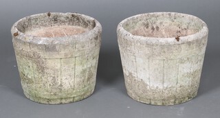 A pair of well weathered barrel shaped concrete garden urns 31cm x 40cm 