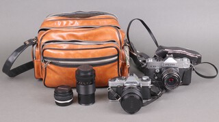 A Petri TTL camera with Carl Zeiss Jena DDR 10005840 MG Flektogon 2,4/35 lens, an Olympus LM20 SLR camera with vivitar 35-70mm lens, a Carl Zeiss Jena DDR lens MC S 1:3,5f=135 lens, an Olympus OM-System Zuiko Auto-S 55mm lens, 2 flash units, a leather effect carrying case and various instructions 