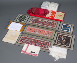 An Indian silk Saree dress and other items of fabric, contained in a plastic box 