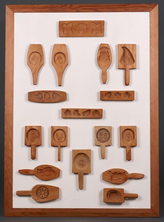 A collection of 17 butter moulds, framed 99cm x 69cm 