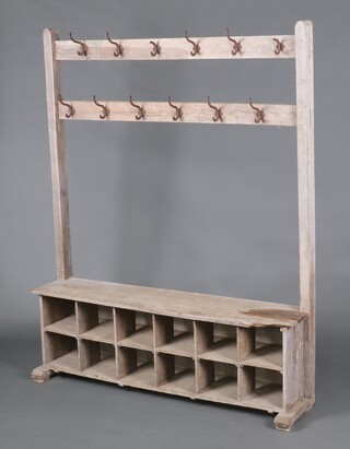 A well weathered oak school type coat rack, the upper section fitted 12 hooks, the base fitted 12 recesses 178cm h x 121cm w x 31cm d (damage, water and contact marks in places ) 