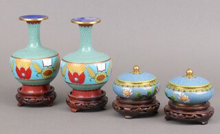 A pair of modern Chinese cloisonne turquoise ground vases 17cm and a pair of ditto circular lidded boxes and covers 7cm with wooden stands 