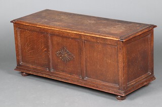 A 1930's oak coffer of panelled construction 46cm h x 104cm w x 44cm d 