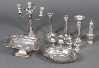 A pair of silver plated candle sticks, a pierced silver plated cake basket, a 3 light candelabrum and other items of silver plate 