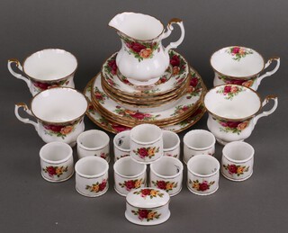Thirteen pieces of Royal Albert Old Country Rose pattern tea ware comprising cream jug, 3 cake plates, side plate, 4 tea cups, 4 saucers and a dish, together with Lady Eleanor napkin rings and a jar and cover 