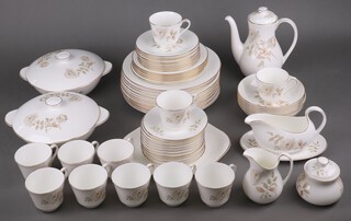 A 62 piece Royal Doulton Old Yorkshire Roses pattern dinner/coffee service comprising 2 tureens and covers, 13 dinner plates, 6 side plates, 9 tea plates, 6 dessert bowls, sauce boat and stand, twin handled plate, coffee pot, sugar bowl, cream jug, 11 cups, 11 saucers 