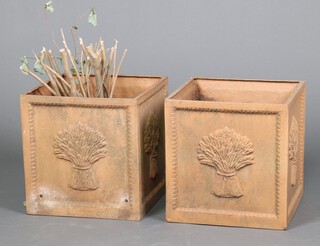 A pair of square fibre glass, terracotta effect, planters decorated sheaths of corn 38cm x 37cm x 37cm 