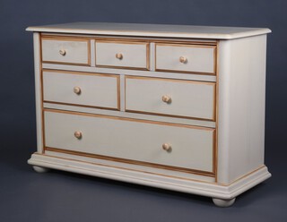 A white laminate dresser base fitted 3 drawers above 2 short and 1 long drawer, raised on bun feet 87cm h x 127cm w x 50cm d (1 foot is loose) 